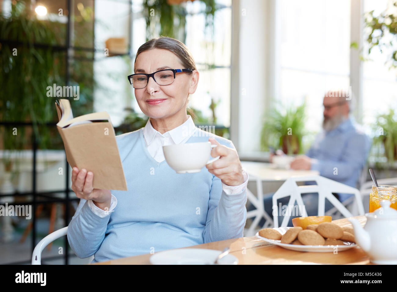 Reading by tea Stock Photo - Alamy