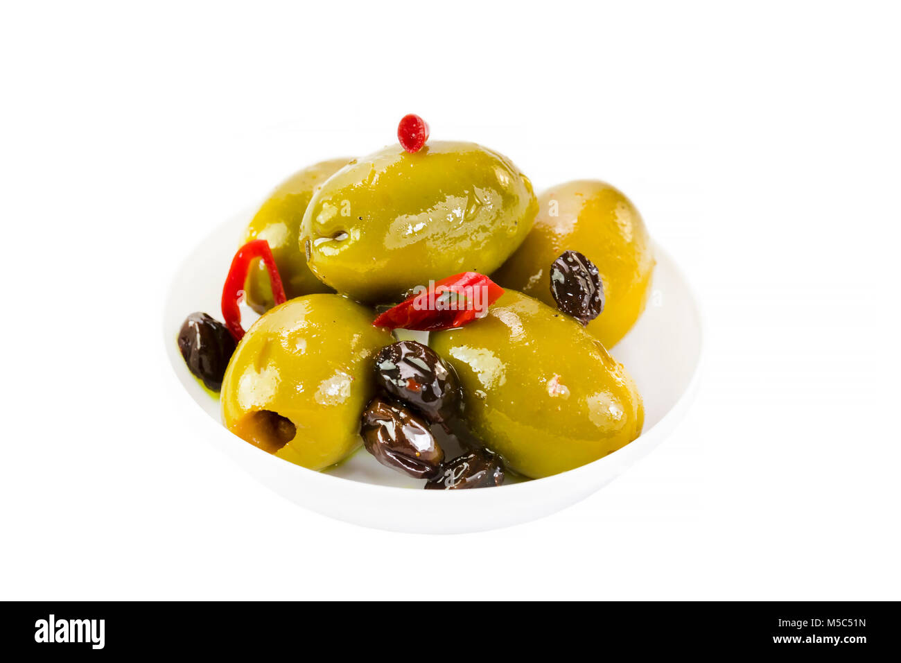 Olives in a small plastic plate on a white background. Stock Photo