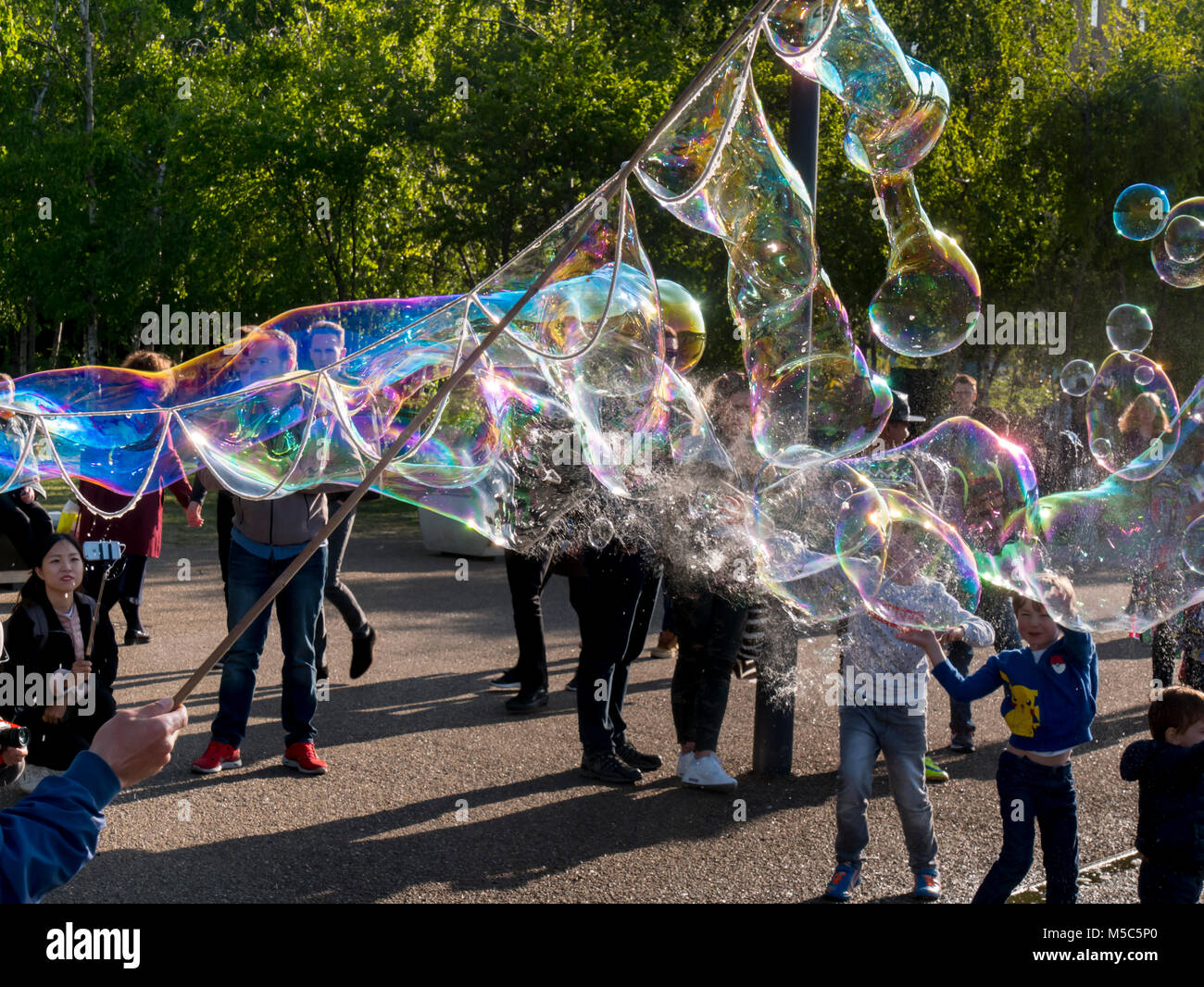 buskers blow bubbles along south bank Stock Photo