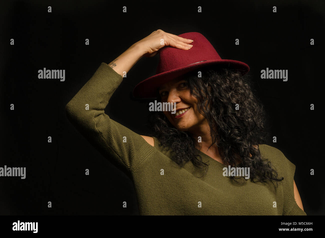 artificial light work in studio, a happy woman with a hat in her hand, Stock Photo