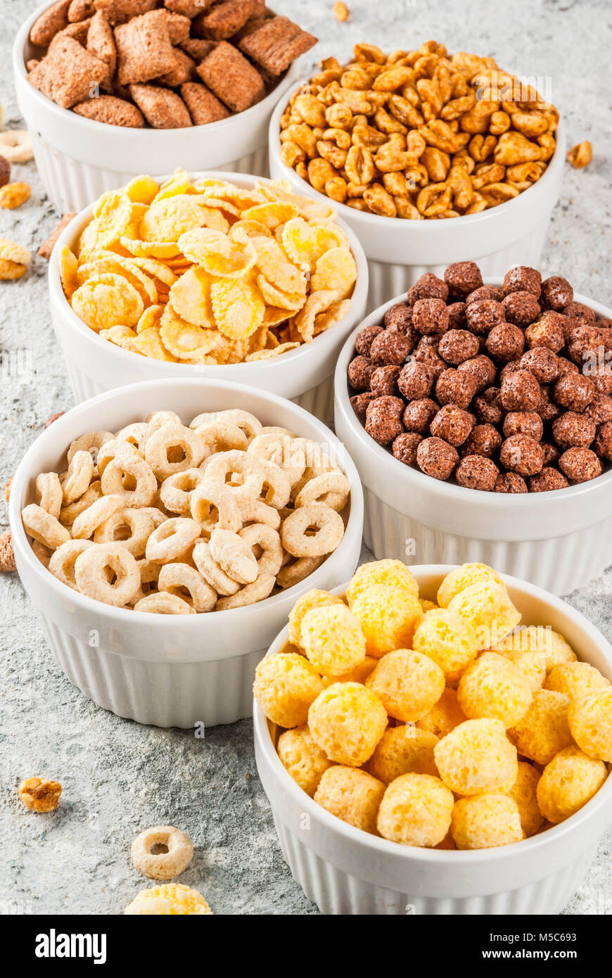 Set of various breakfast cereal corn flakes, puffs, pops, grey stone