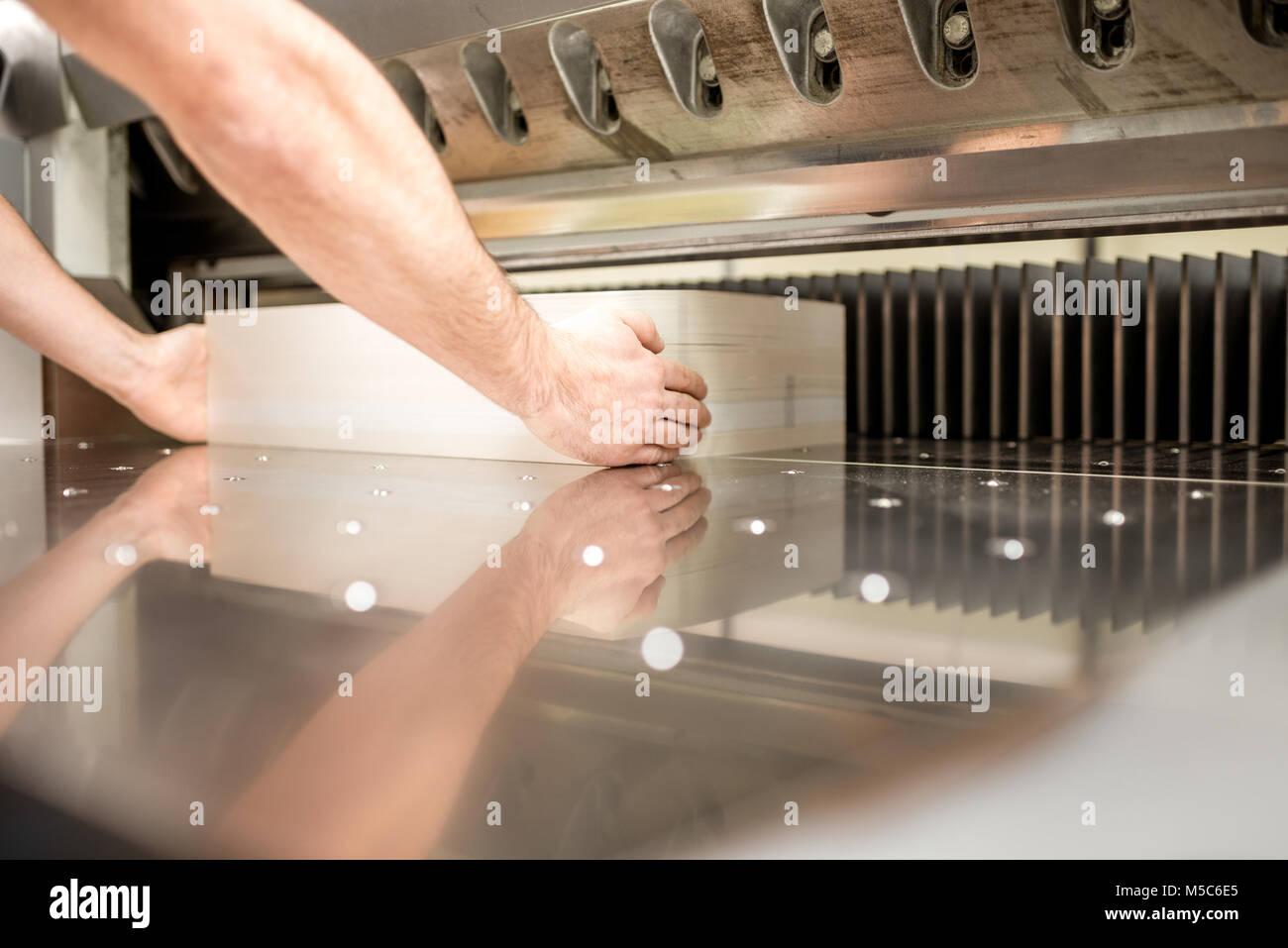 Cutting a stack of paper for printing at the factory Stock Photo Alamy