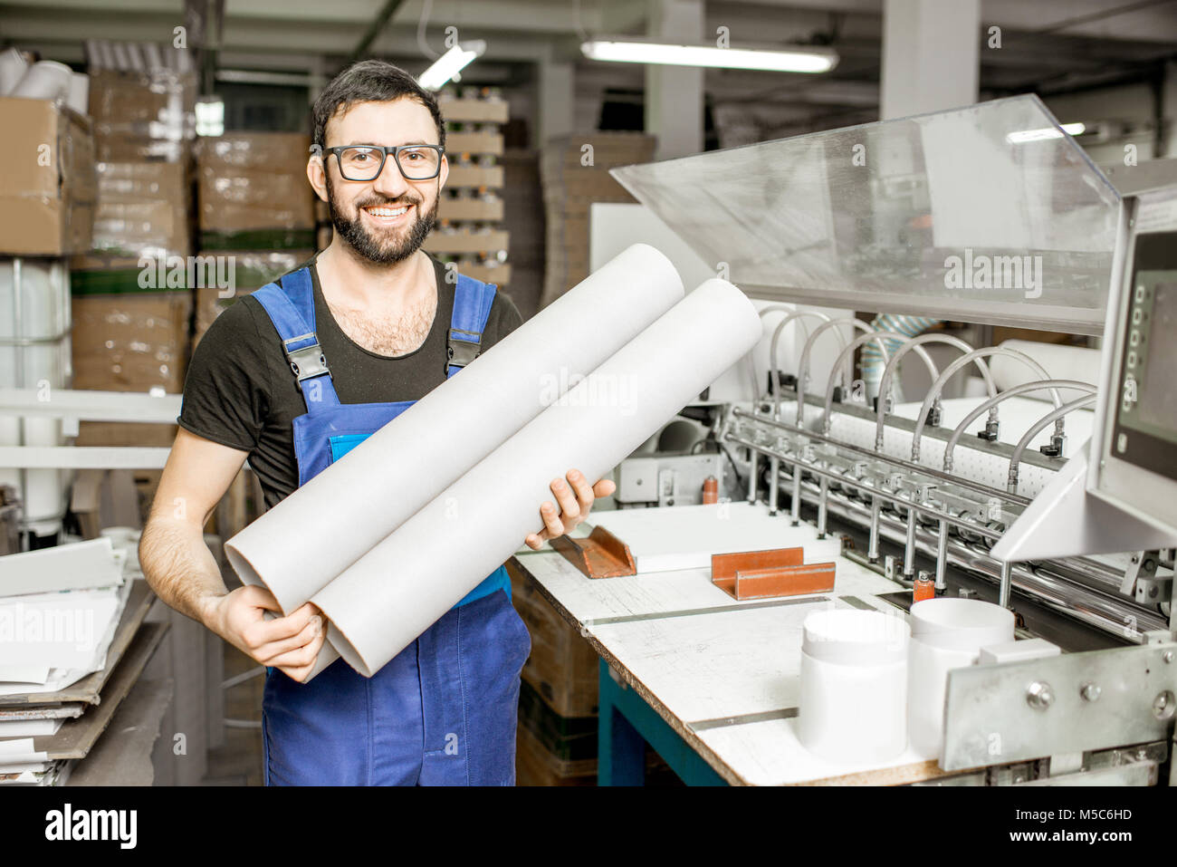 Worker portrait with paper tubes Stock Photo - Alamy