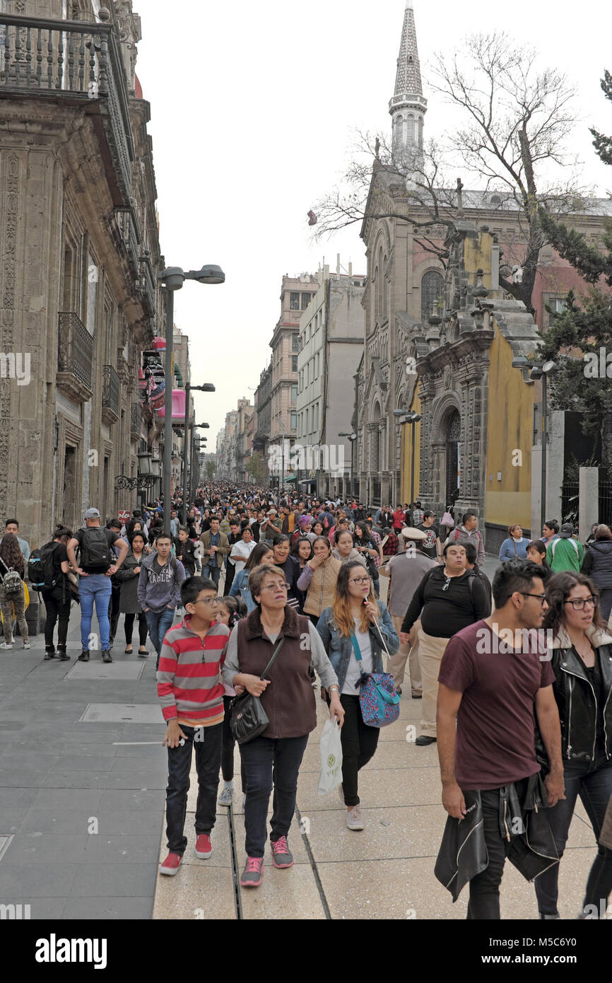 Pedestrians make there way along Calle 5 de Mayo in the Centro Historico district of Mexico City, Mexico. Stock Photo