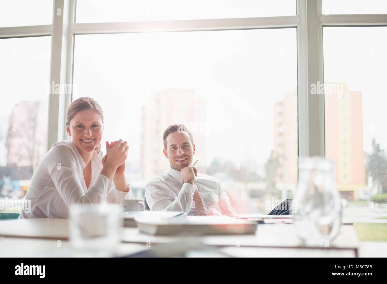 Portrait of smiling young business people in meeting room Stock Photo ...