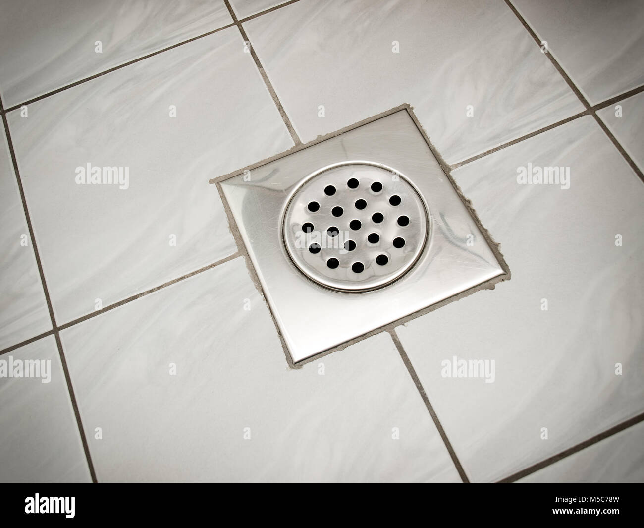 Drain on the floor of a bathroom or a kitchen. Stock Photo
