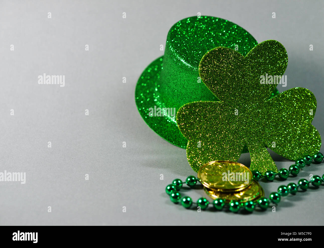 St Patrick's Day green sparkle top hat, four leaf clover, gold coins ...