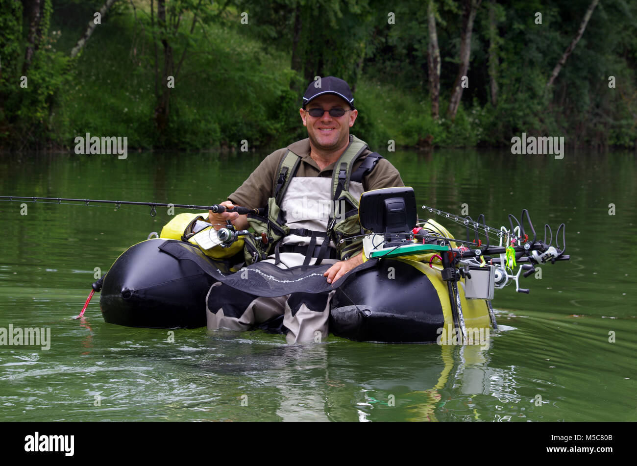 https://c8.alamy.com/comp/M5C80B/fishing-with-a-float-tube-the-man-is-sitting-in-the-fishing-inflatable-M5C80B.jpg