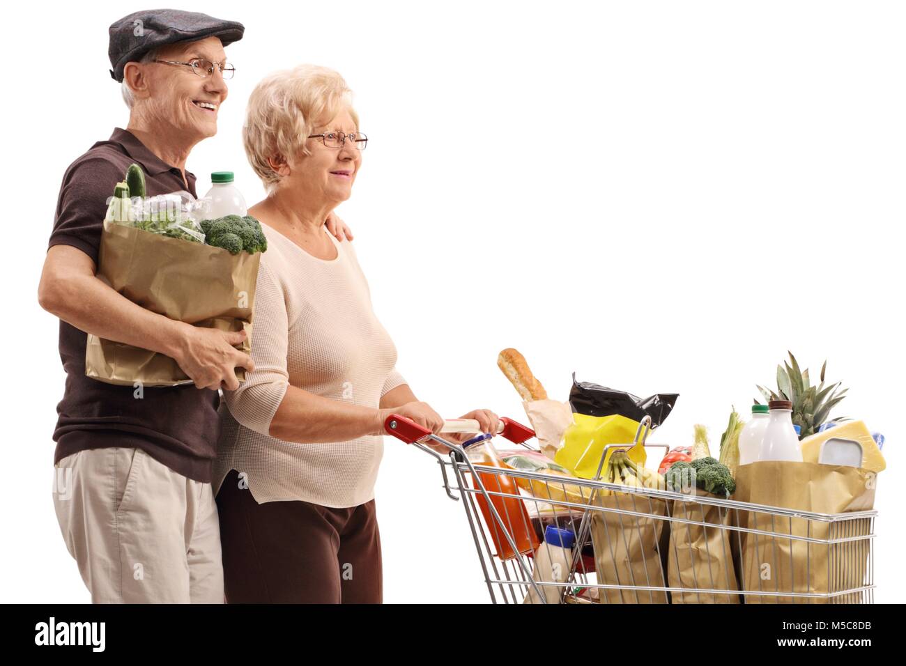 Old woman pushing shopping trolley hi-res stock photography and images ...