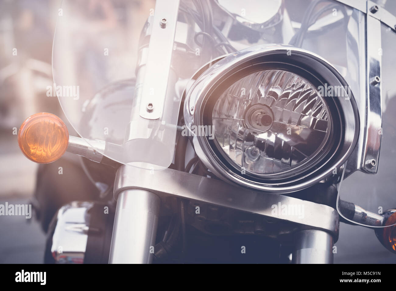 Vintage motorbike, focus on a headlamp. Retro motorcycle with headlight