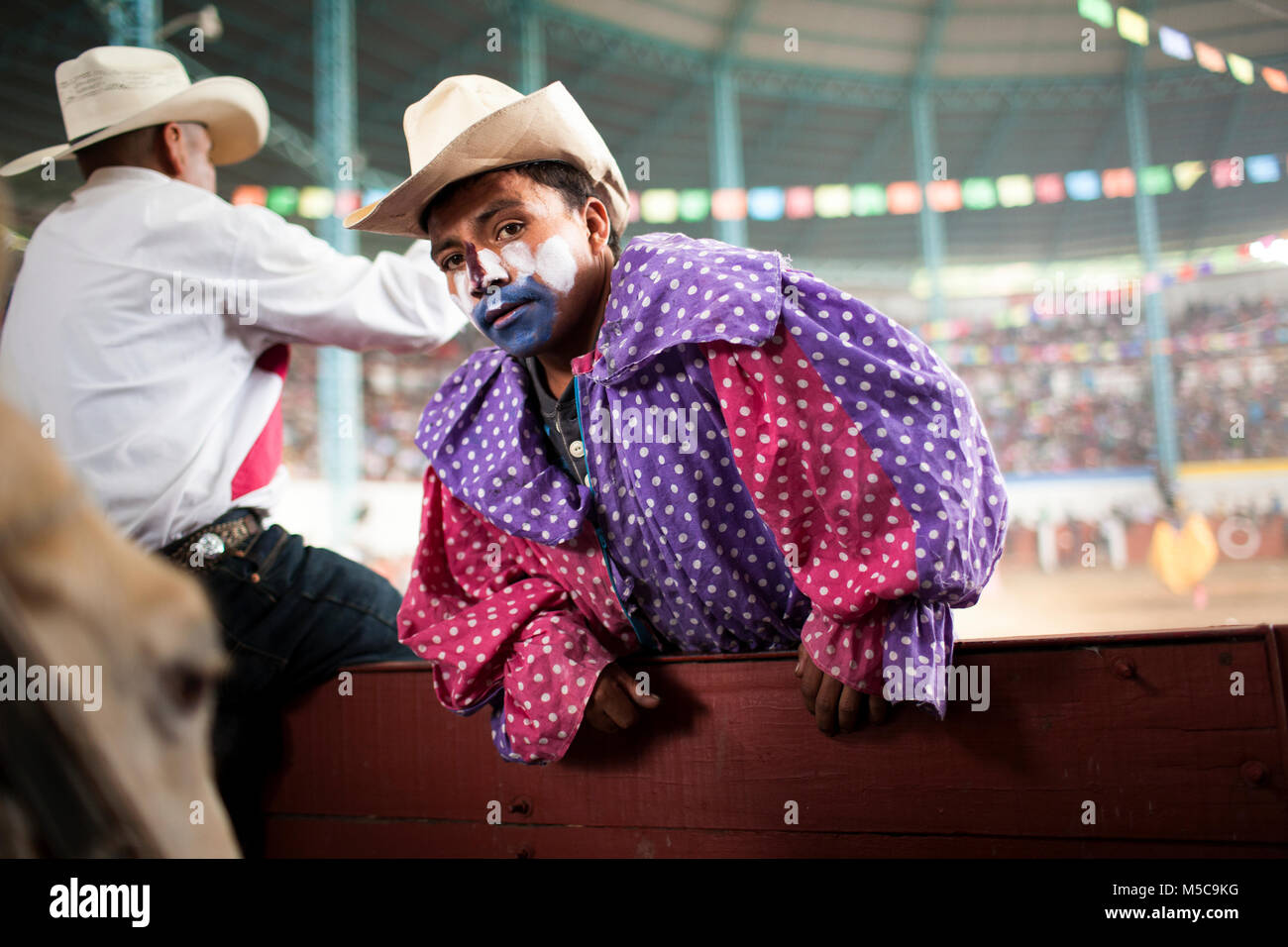 A rodeo clown during the fall fiesta rodeo in Cheran, Michoacan, Mexico on Tuesday, October 7, 2014. The town of Cheran holds two annual fiestas to celebrate their culture and religious beliefs.   In April 2011, after years of extortion by the local cartels and complacency of local government and police, the people of Cheran reclaimed their town and their land. The Pueblo (translated as people or community) confronted the cartel, removed the government from office, and created their own police force to guard the city. Stock Photo