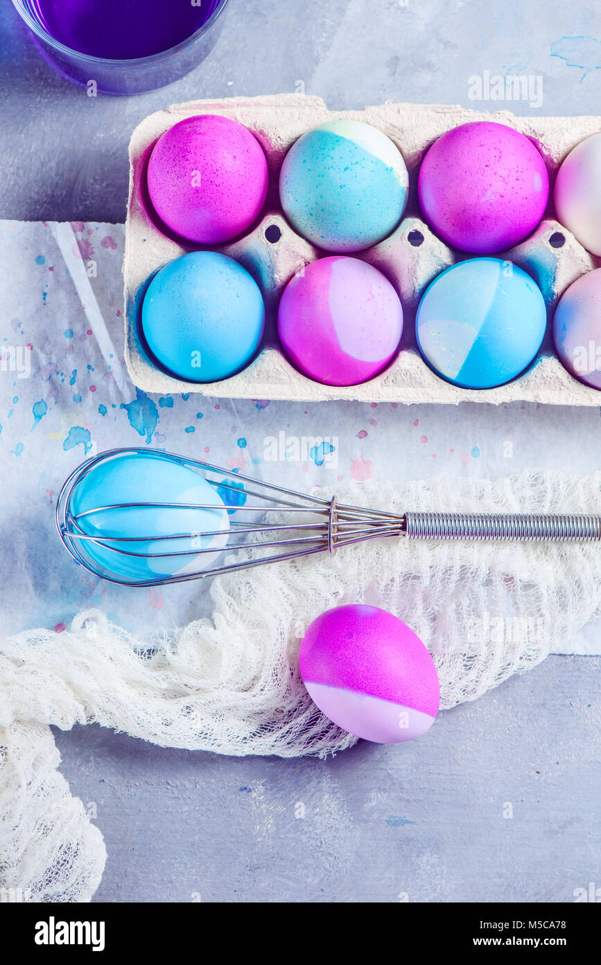 Fresh Easter eggs painted with a whisk. Easy Easter lifehack. View from above with copy space. Stock Photo
