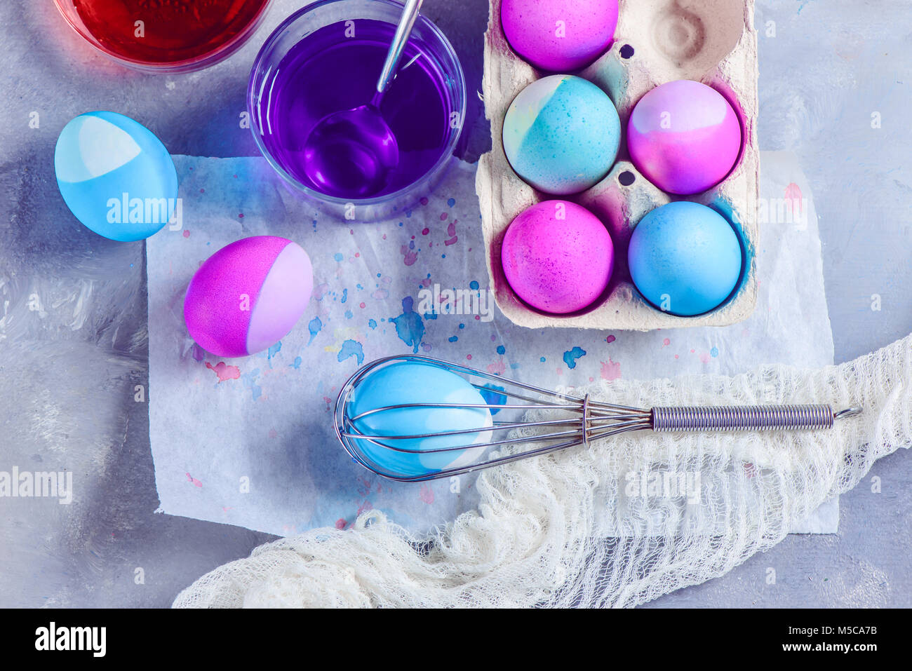 Fresh Easter eggs painted with a whisk. Easy Easter lifehack. View from above with copy space. Stock Photo