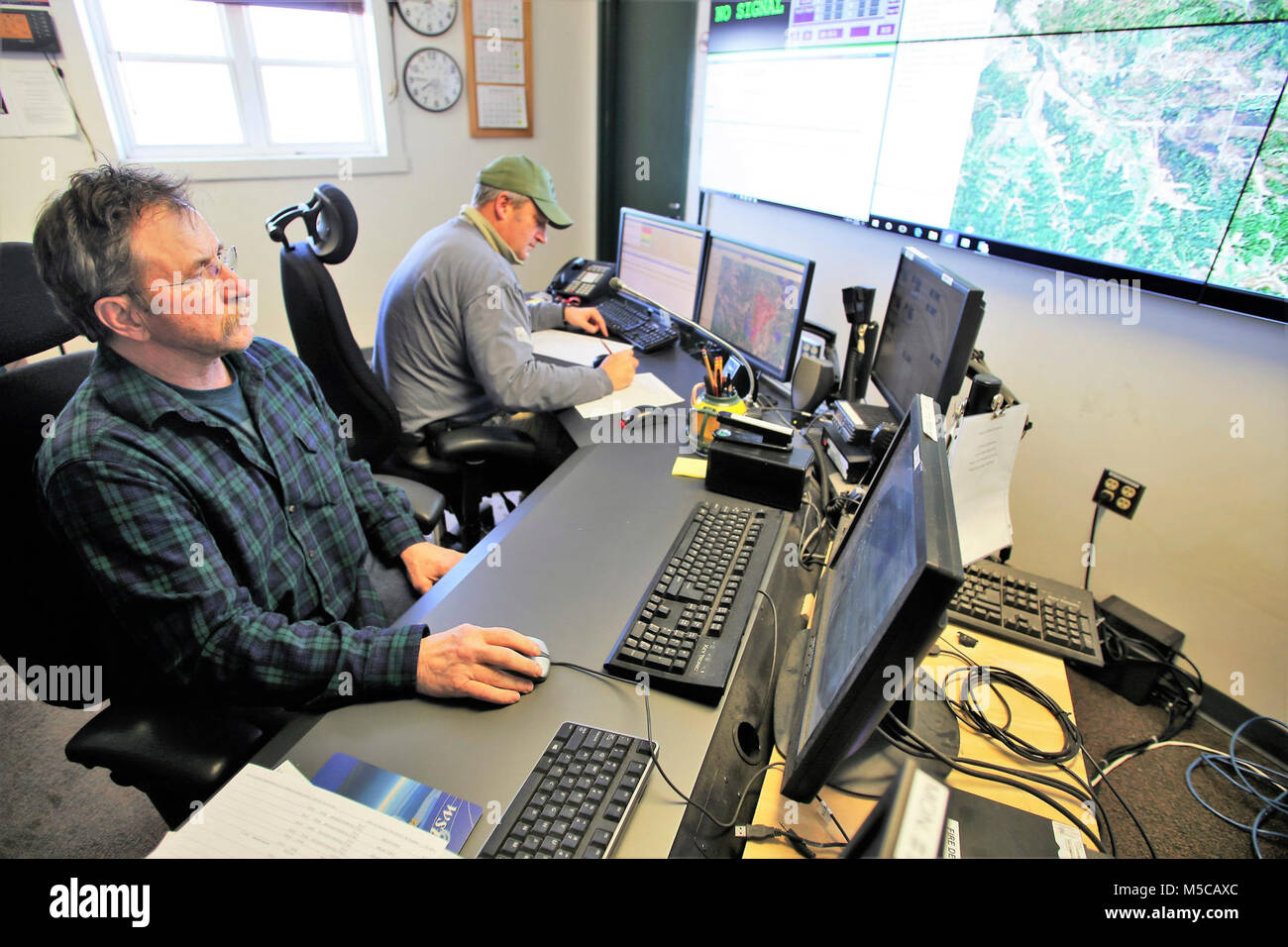 Range Control Technician Mark Confer and Fire Desk Supervisor Tim Caucutt with the Directorate of Plans, Training, Mobilization and Security work at the Fire Desk on Jan. 16, 2018, at Fort McCoy, Wis. The desk operates communications with units using the range complex as well as Range Maintenance and other personnel throughout 46,000 acres of training areas on Fort McCoy. (U.S. Army Stock Photo