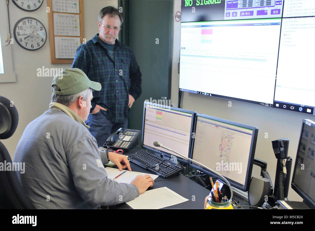 Range Control Technician Mark Confer and Fire Desk Supervisor Tim Caucutt with the Directorate of Plans, Training, Mobilization and Security work at the Fire Desk on Jan. 16, 2018, at Fort McCoy, Wis. The desk operates communications with units using the range complex as well as Range Maintenance and other personnel throughout 46,000 acres of training areas on Fort McCoy. (U.S. Army Stock Photo
