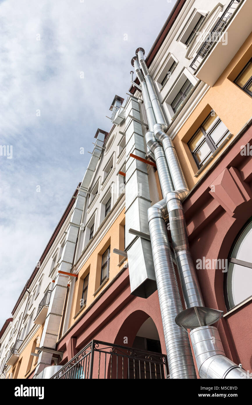 bottom-up view on a traditional european building with ventilation pipes Stock Photo