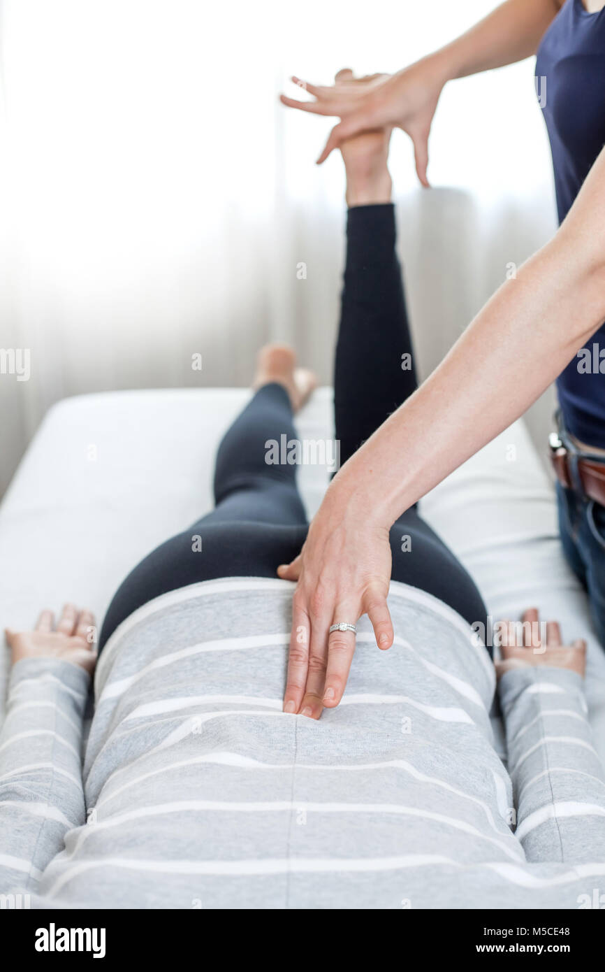 Therapist giving Kinesiology treatment. Stock Photo