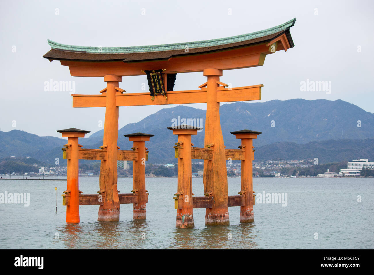 Itsukushima, also known as Miyajima, is a small island in Hiroshima Bay.Just offshore is the giant, orange Great Torii Gate. Stock Photo