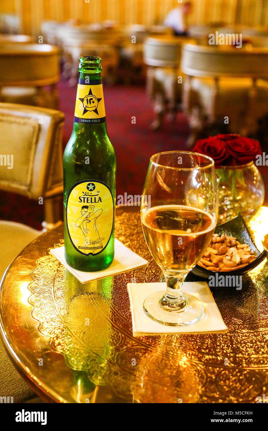 A bottle of Stella Egyptian Beer or lager and a glass in a hotel lounge bar Stock Photo