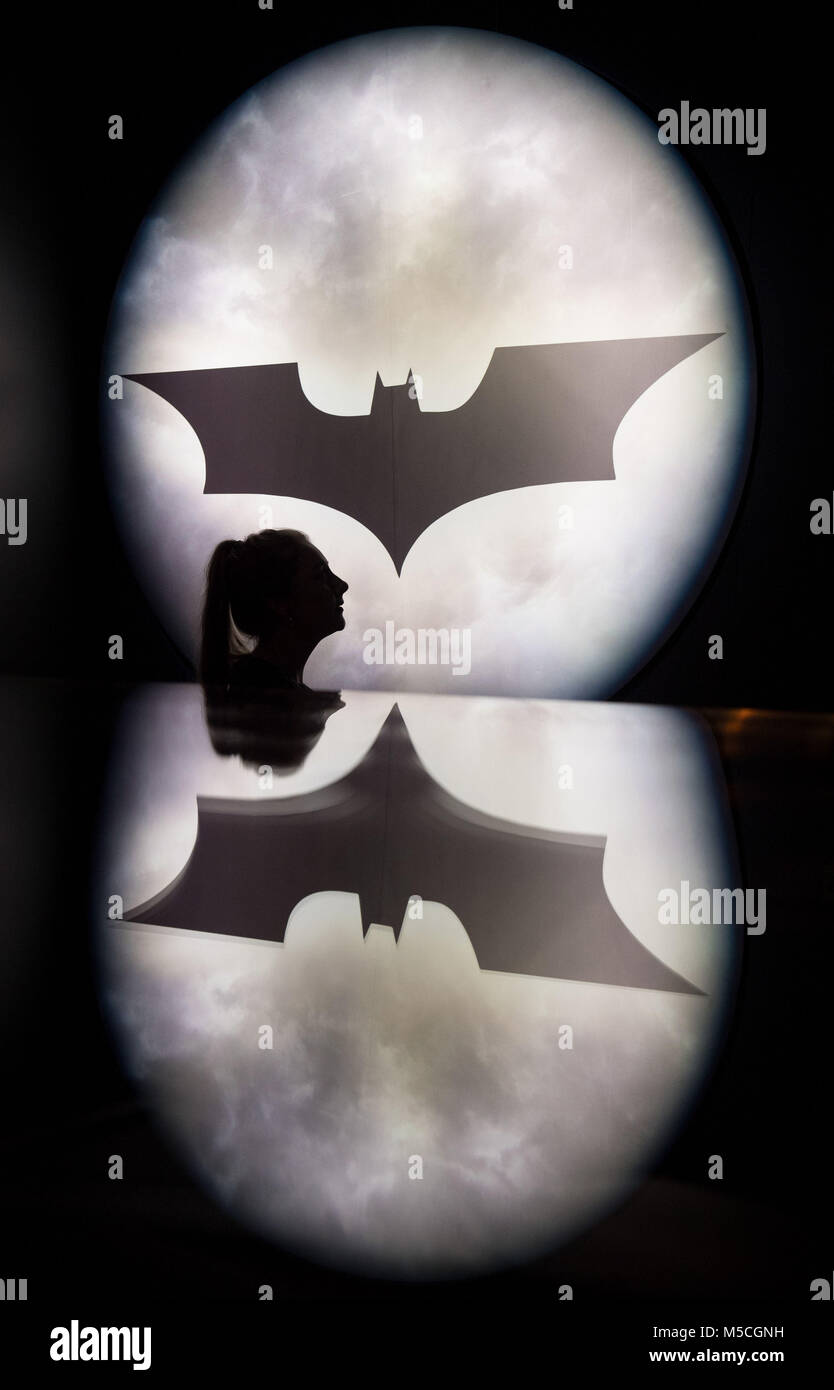 Emily Talbot with a projection of the bat signal, as featured in the Batman comics and movies, at the opening of DC Exhibition: Dawn of Super Heroes at the O2 in London. Stock Photo