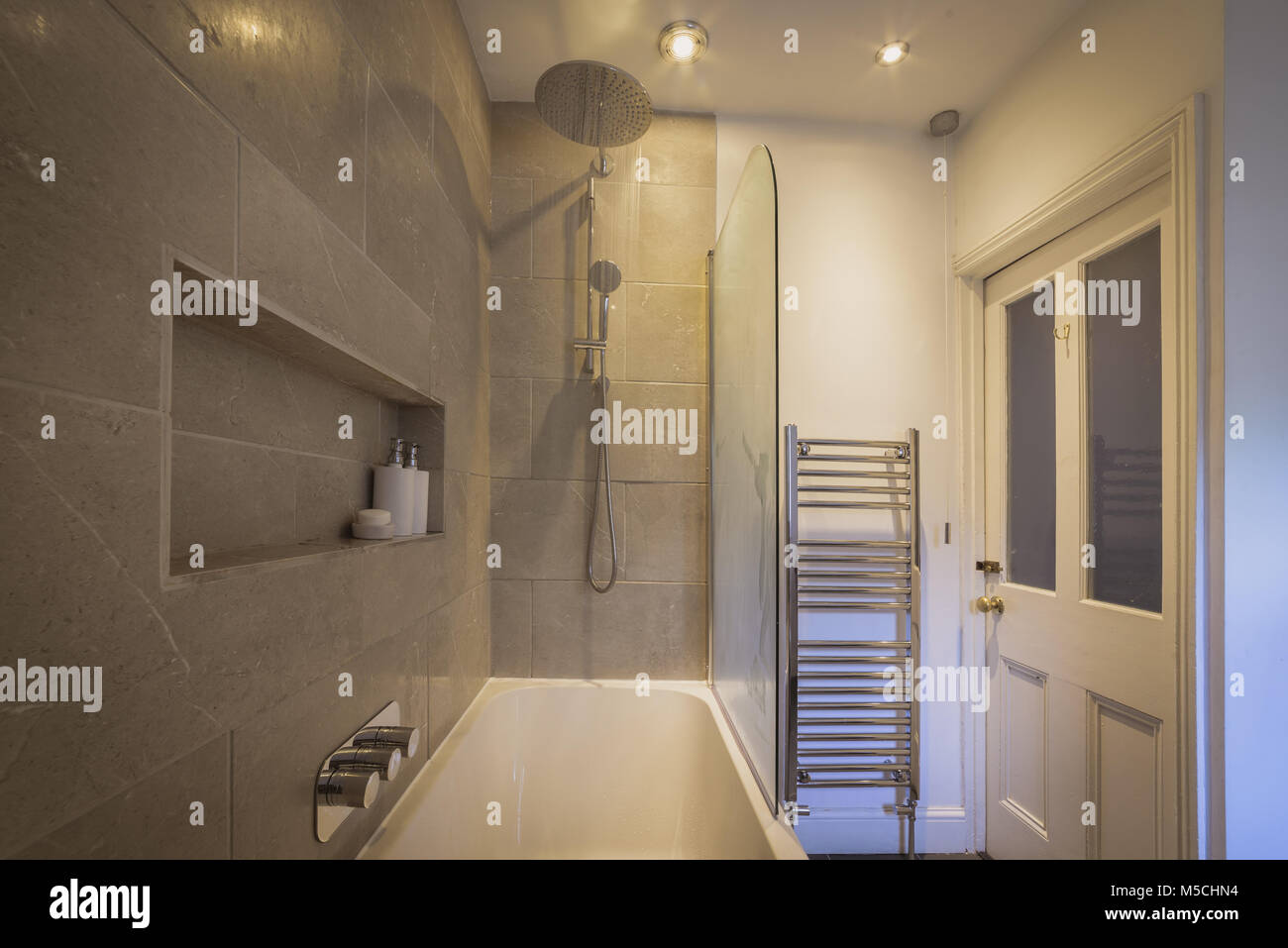 Rainfall shower over bath & tiled area, contemporary bathroom Stock