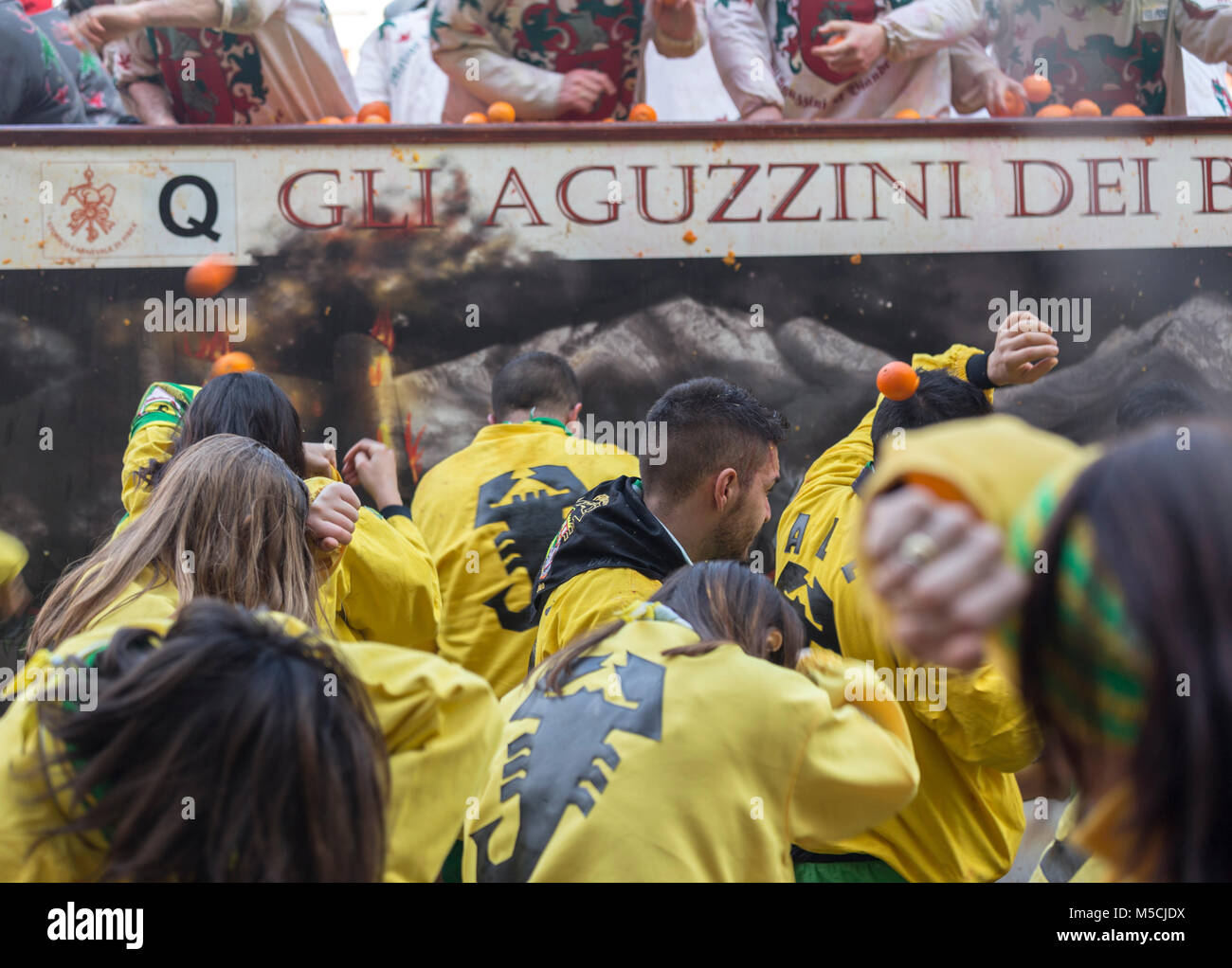 IVREA, ITALY - 11 FEBRUARY 2018: participants of the orange battle during historic carnival in Ivrea, Italy. Stock Photo