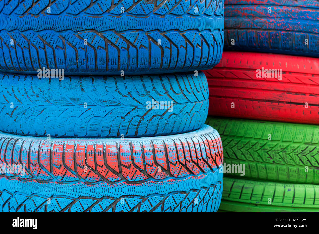 Colored tires painted in blue, green and red colors Stock Photo