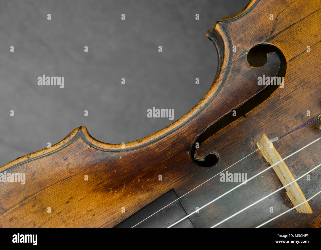 part of violin with f hole against gray background Stock Photo Alamy