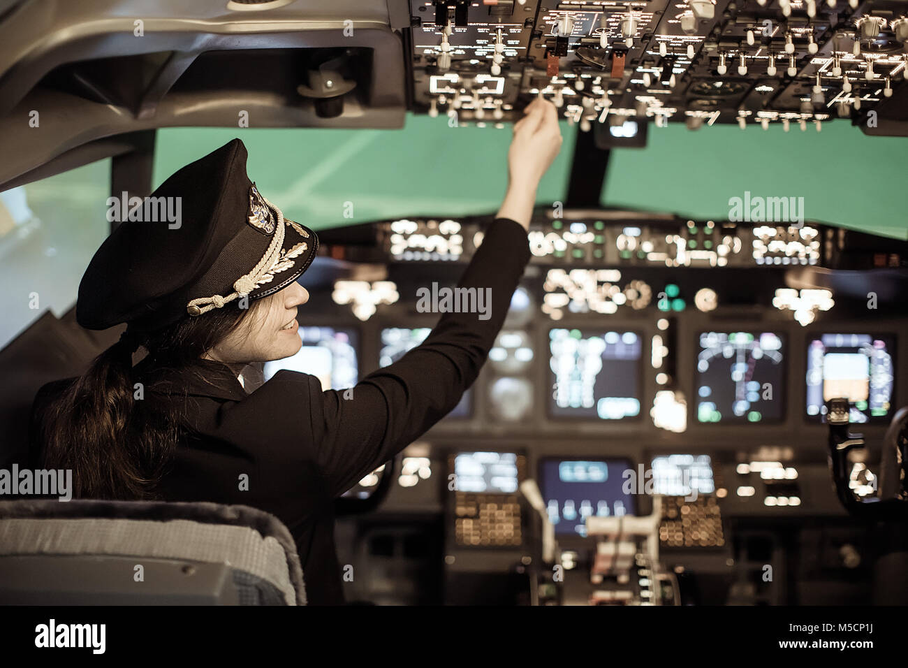A woman flying an airplane Stock Photo