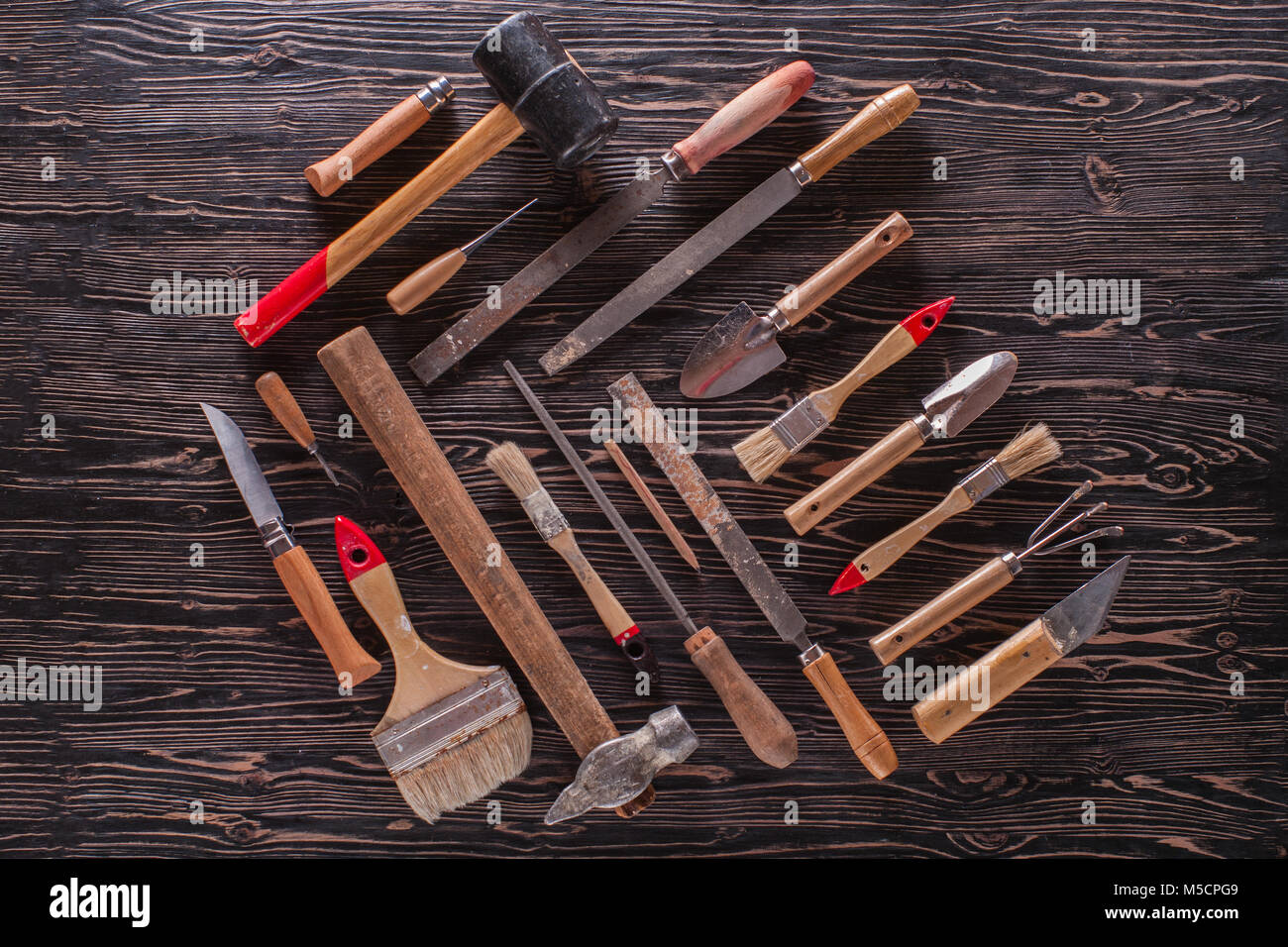 Assorted work tools on wooden black table. Stock Photo