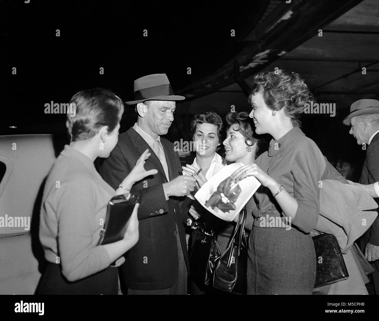 Frank Sinatra, singer & actor arriving in Chicago at the Illinois Central Depot on City of Miami train, March 29, 1960. Image from original camera negative. Stock Photo