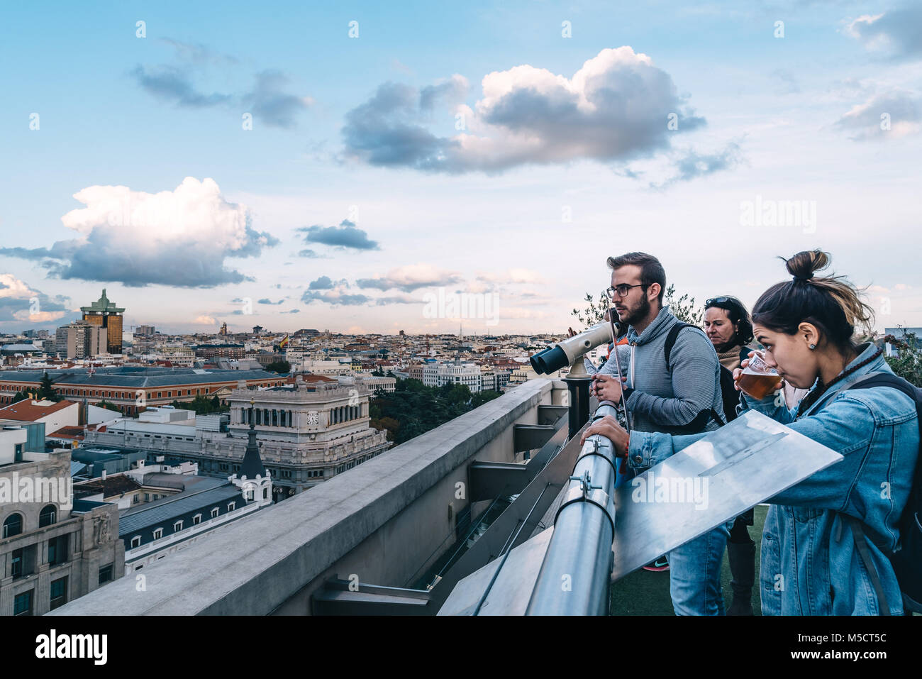 Madrid, Spain - November 3, 2017:  People looking at skyline at rooftop on Circulo de Bellas Artes of Madrid at sunset. Stock Photo