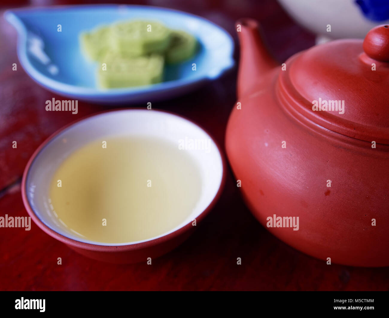 Traditional chinese tea set compose of cup of tea, teapot, and snack on
