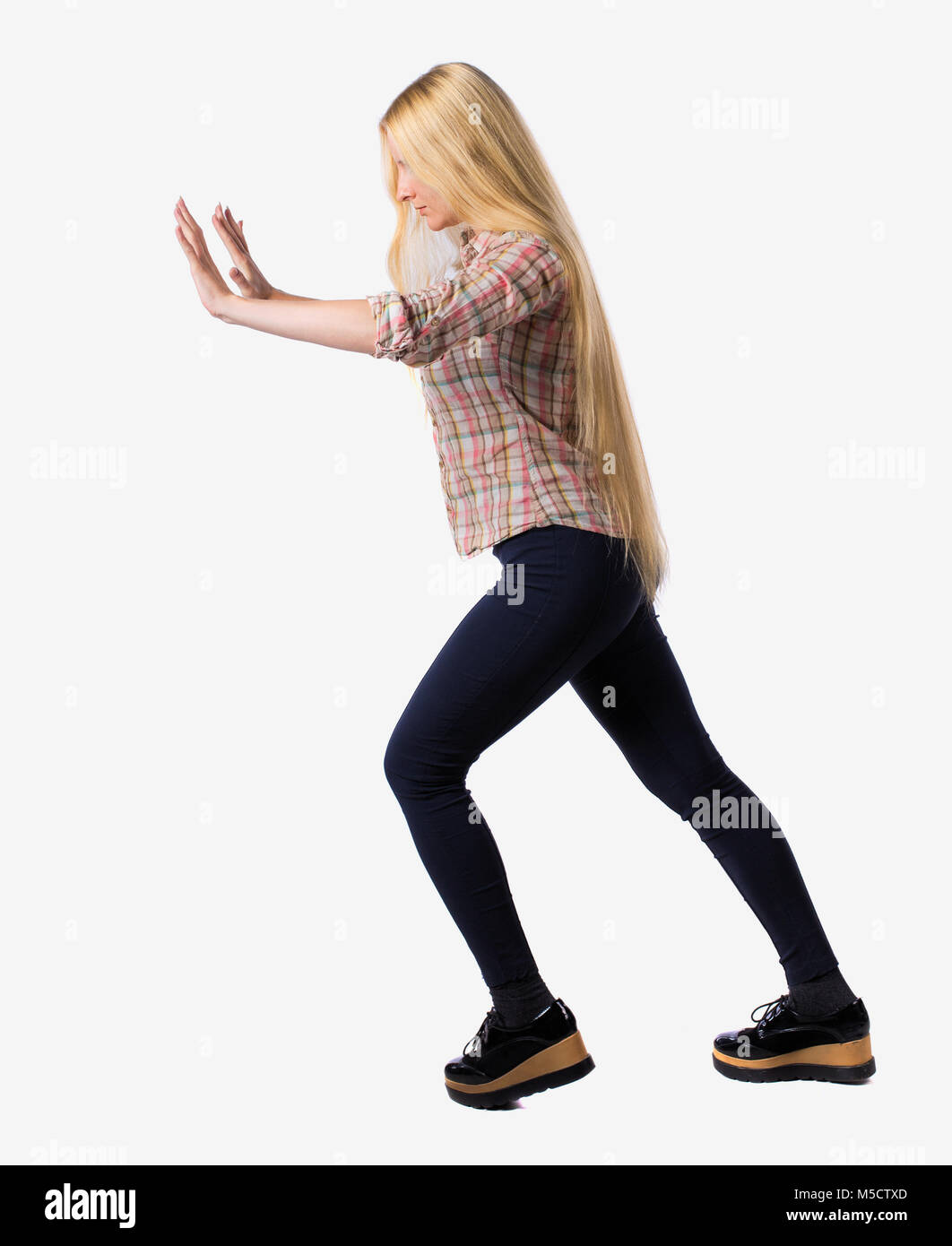 Pushing Back View back view of woman pushes wall. Isolated over white background. Rear ...