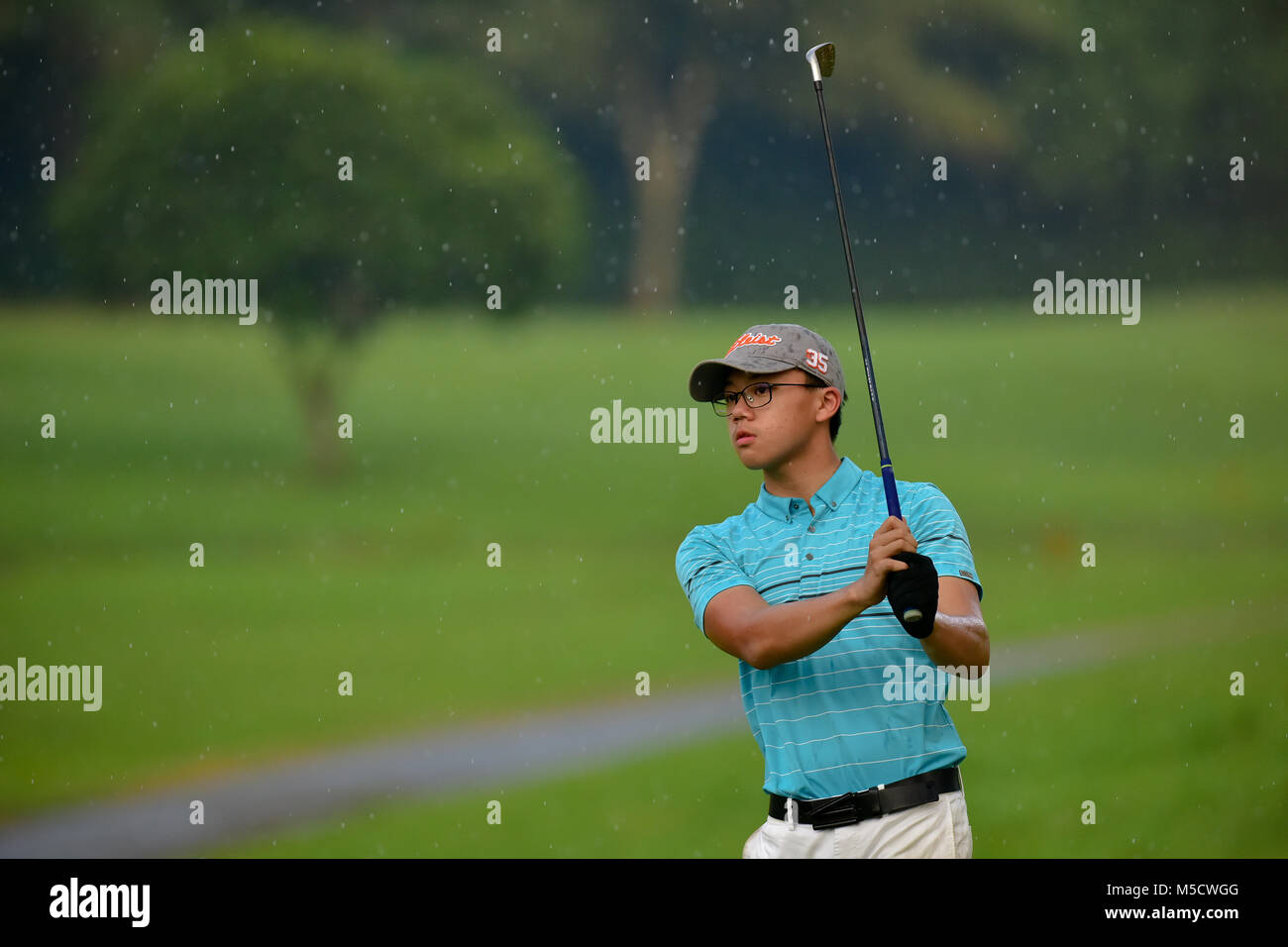 Danau, UKM Bangi - FEBRUARY 10: Joshua Lim jun Wen takes his tee shot on the 16th hole during Round One of the Danau Junior Championship at Danau Golf Stock Photo