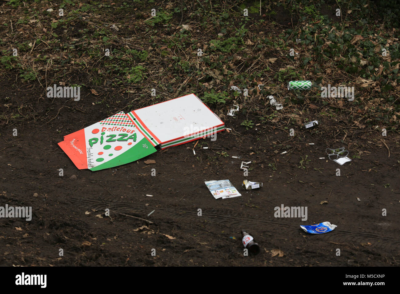 Pizza box and assorted cans and bottles thrown from a car in the countryside near Stourbridge, West midlands, uk. Stock Photo