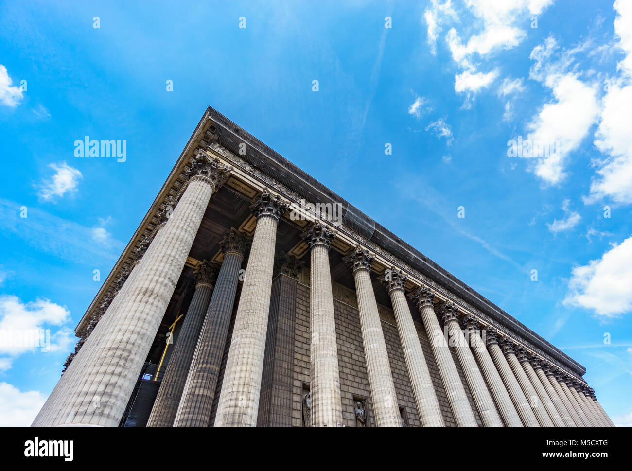 Bottom view of Magdalenae church corner in Roman style. Paris, France Stock Photo