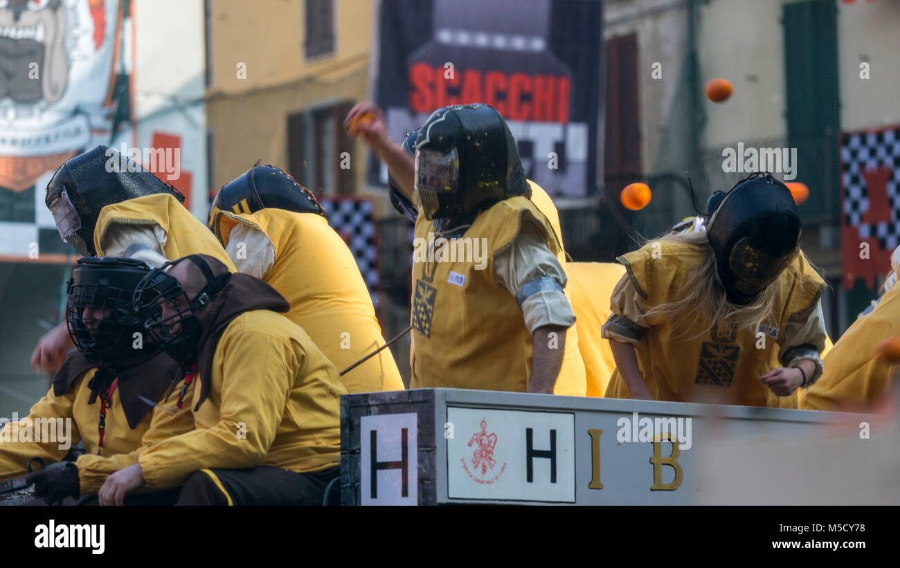 IVREA, ITALY - 11 FEBRUARY 2018: participants of the orange battle during historic carnival in Ivrea, Italy. Stock Photo