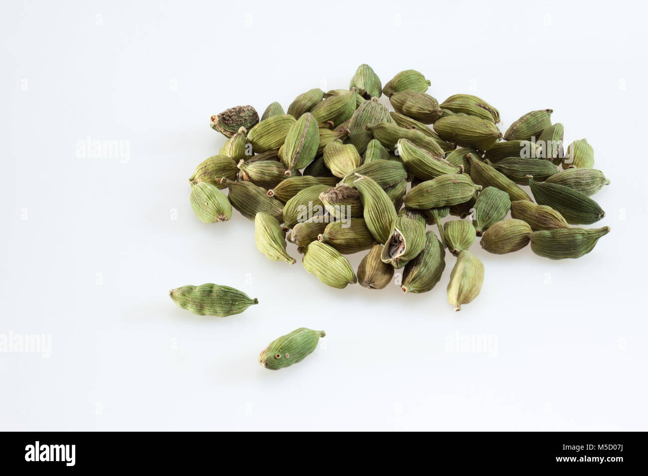 Green cardamom pods on a clean white background Stock Photo