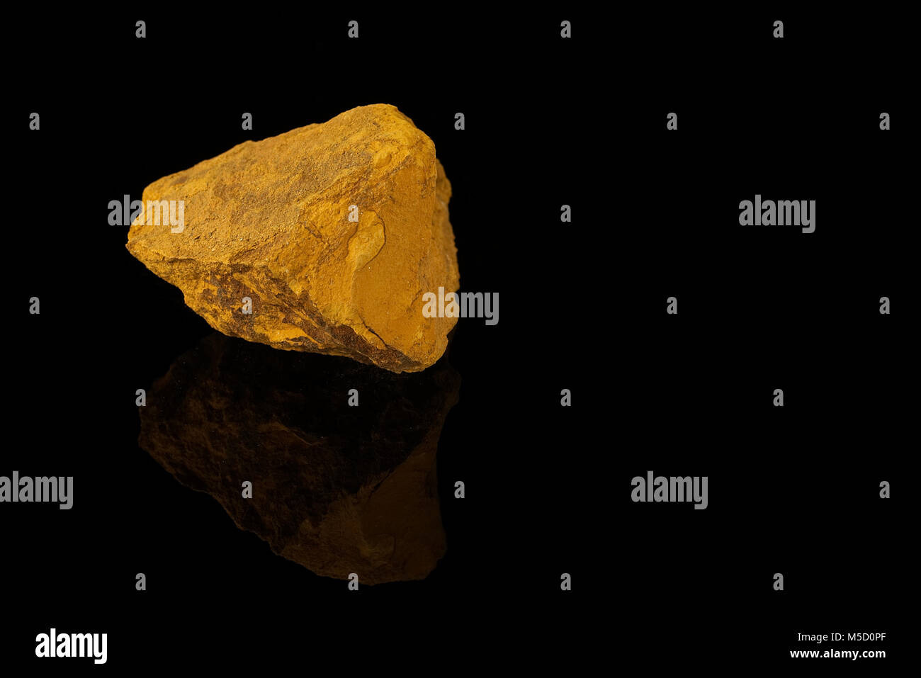 Limonite, iron ore mineral, iron oxide-hydroxide, amorphous, mineraloid, fine grained aggregate with powdery coating isolated on black background.rock Stock Photo