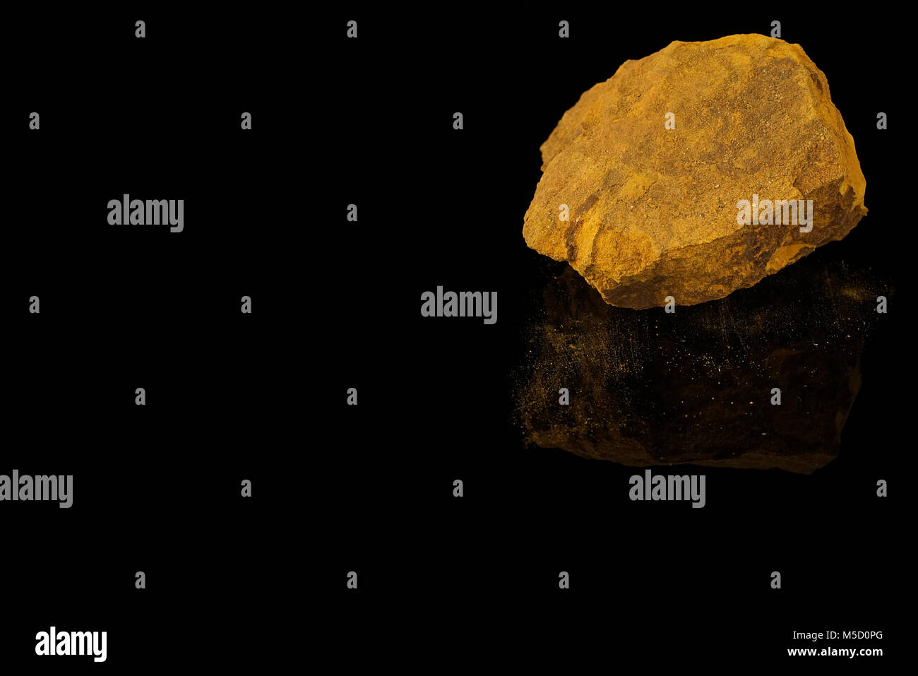 Limonite, iron ore mineral, iron oxide-hydroxide, amorphous, mineraloid, fine grained aggregate with powdery coating isolated on black background.rock Stock Photo