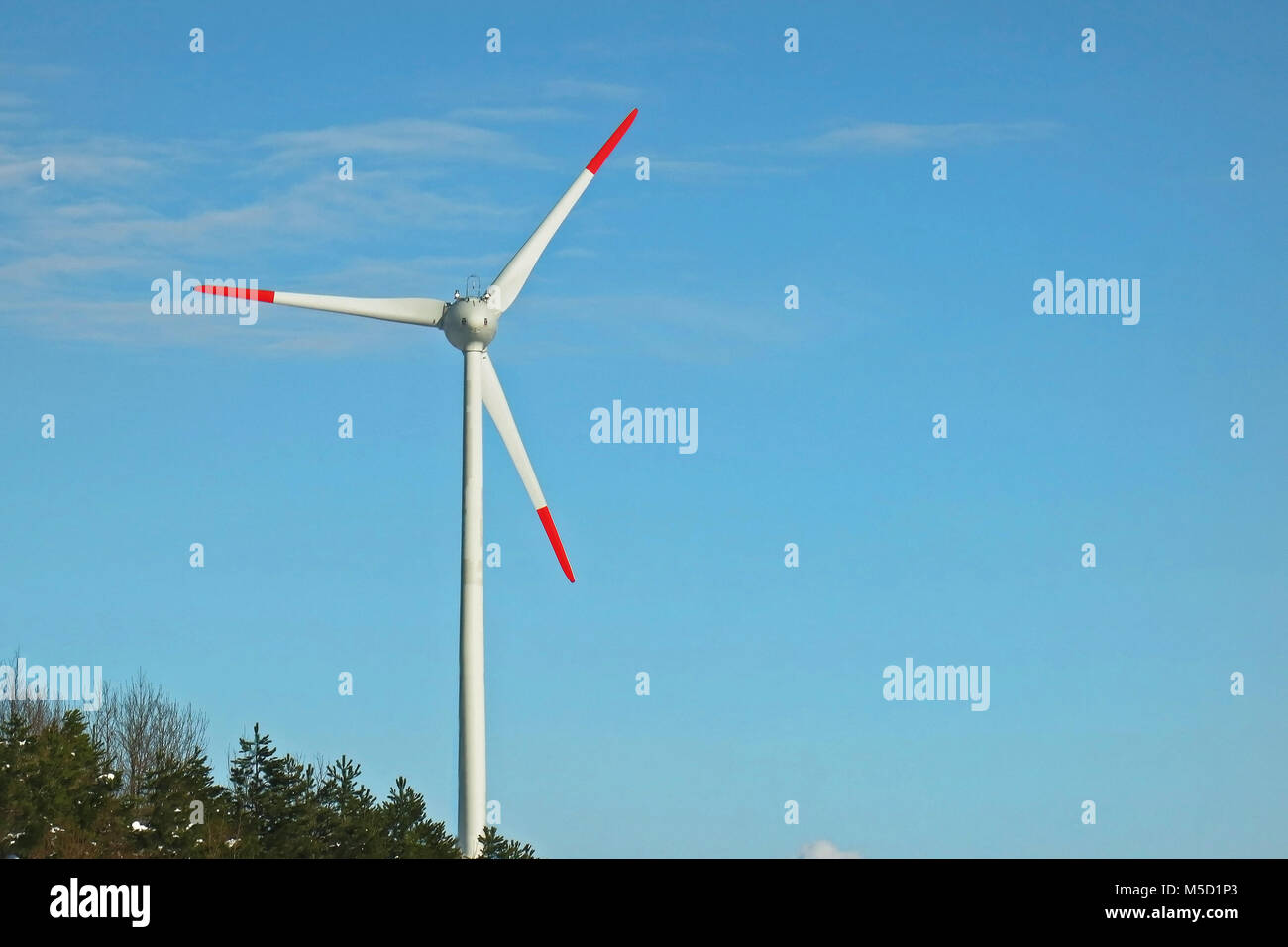Single wind turbine on a blue sky creating clean energy Stock Photo - Alamy