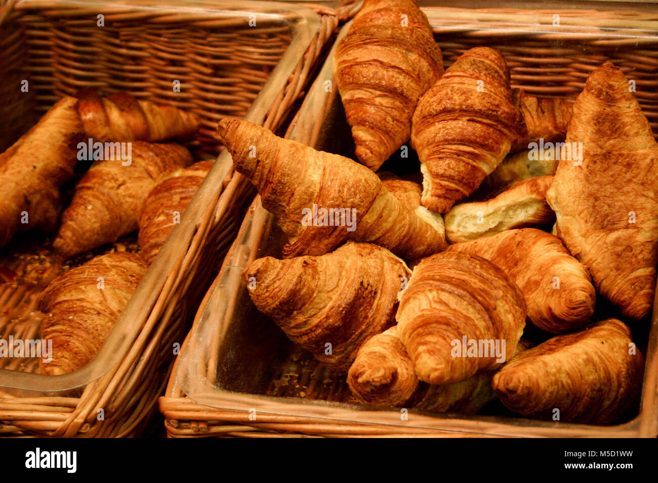 puffy-golden-brown-croissants-in-sales-wicker-baskets-freshly-baked