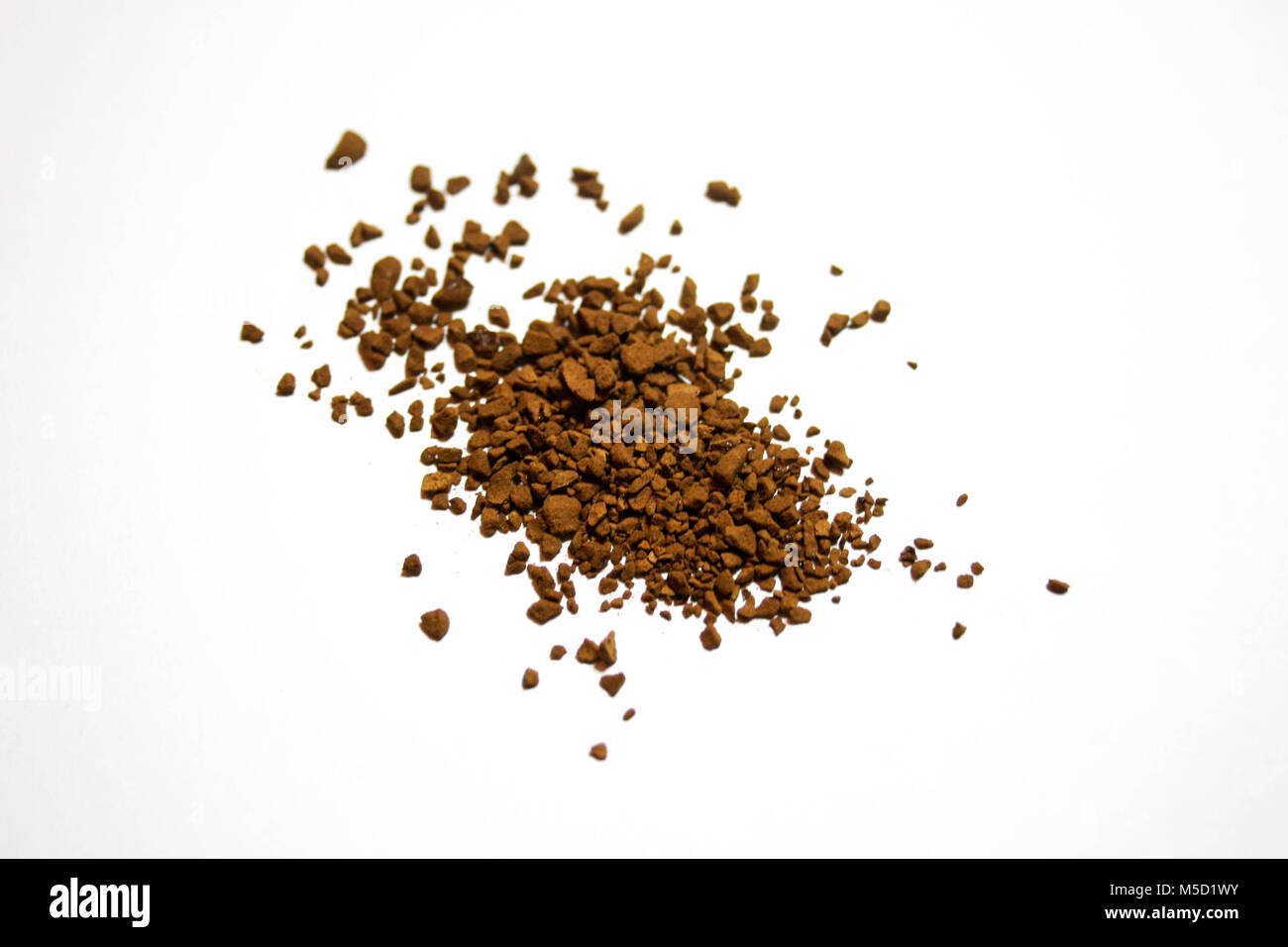 Heap pile of brown coffee granules, on white studio background, close up Stock Photo