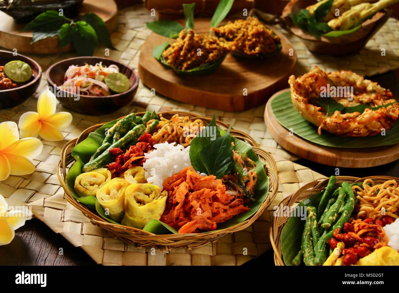 Nasi Campur Bali. Popular traditional Balinese dish of steamed rice served with various side dishes. Stock Photo