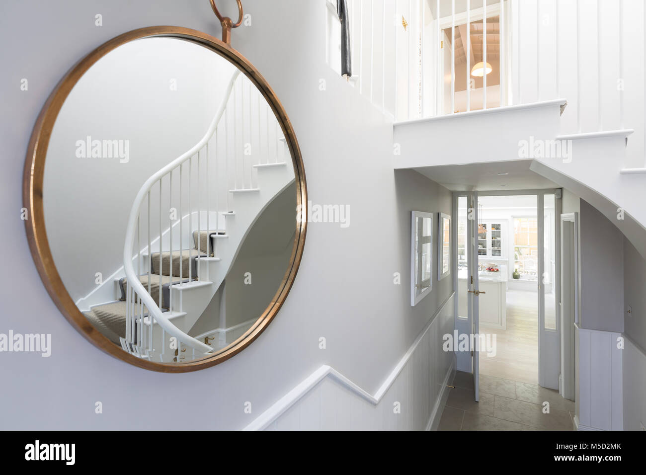 Reflection of foyer staircase in round mirror Stock Photo Alamy