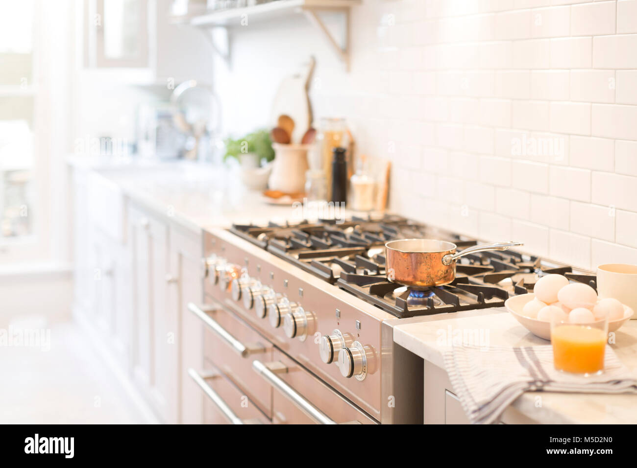 Copper pot on kitchen stove Stock Photo