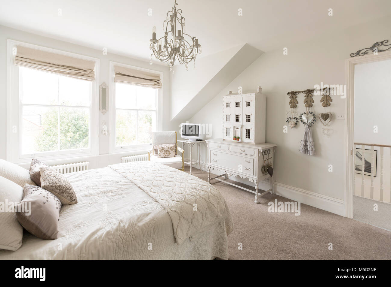 White, luxury home showcase interior bedroom with chandelier Stock Photo