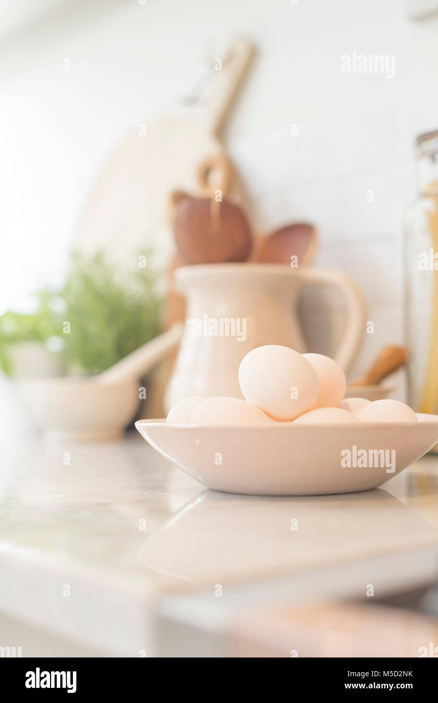Still life eggs in bowl on kitchen counter Stock Photo