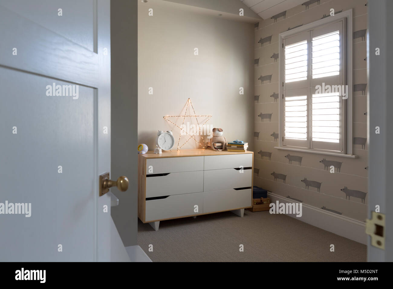 Illuminated string light star on dresser in child’s bedroom Stock Photo